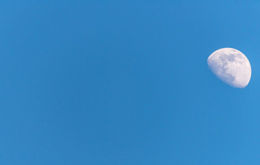 Wall Mural - Three Quarter Moon in a Blue Sky