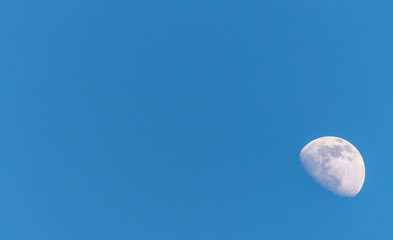 Wall Mural - Three Quarter Moon in a Blue Sky