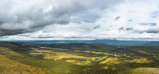 Wall Mural - panoramic overview over a valley with forest and lakes in sweden on a cloudy day