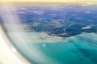 View from the side of the plane on the sea and the mainland of Malaysia. Avani Gold Coast Sepang top down view.