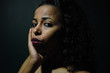 © Sherif - young naked African woman posing at studio, face with hand portrait over dark background