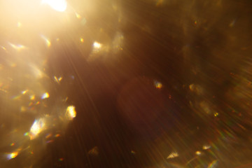 Easy to add lens flare effects for overlay designs or screen blending mode to make high-quality images. Abstract sun burst, digital flare, iridescent glare over black background. Defocused bokeh.