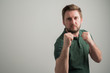 © Cipri Suciu  - Portrait of serious stylish attractive man with thick beard, dressed in casual green t shirt showing fists like fighting