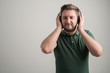 © Cipri Suciu  - Portrait of serious stylish attractive man with thick beard, dressed in casual green t shirt listen music