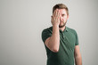 © Cipri Suciu  - Portrait of serious stylish attractive man with thick beard, dressed in casual green t shirt covering one eye