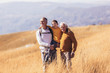 © Mediteraneo - Three generations of family hiking together in the autumn.
