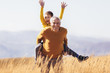 © Mediteraneo - Grandson piggyback with his grandfather in autumn.