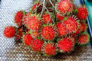 Wall Mural - bunch of red rambutans on bamboo tray.