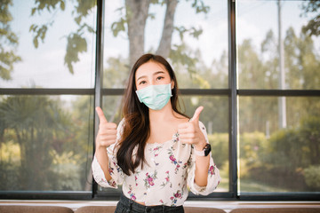 Coronavirus and Air pollution pm2.5 concept.Little Asia girl mask for protect pm2.5 and show stop hands gesture for stop corona virus outbreak.Wuhan coronavirus and epidemic virus symptoms.