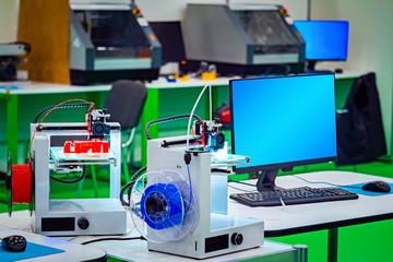 Poster - 3D printer. The method of layer-by-layer model creation. The creation of real objects made of different materials. The printer prints a three-dimensional object. Printing models of red and blue colors