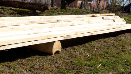 Wall Mural - a pile of fresh pine planks on the ground