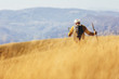 © Mediteraneo - Senior man on hike through beautiful countryside in autumn.