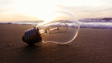 Close-up Of Light Bulb At Beach During Sunset
