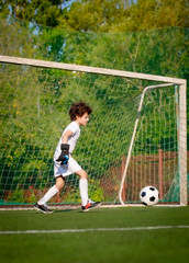 Wall Mural - Summer soccer tournament for young kids. football club. emotions and joy of the game. Young goalie. Kids - soccer champion. Boy goalkeeper in football sportswear on stadium with ball. Sport concept.