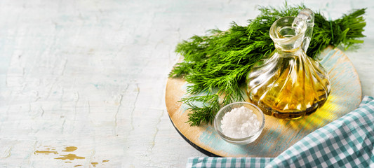 Wall Mural - Olive oil bottle, herbs, salt on vintage light blue background