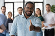 Smiling African American male employer in glasses stretch hand welcome new employee or intern in office, happy biracial boss or businessman meet greet newcomer at workplace, employment concept