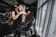© Тарас Нагирняк - Portrait of handsome sportsman making cardio workout and boxing exercise on stationary treadmill in the gym