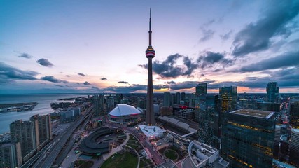 day to night time lapse view of toronto cityscape showing architectural landmark cn tower and downto
