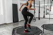 Fitness trainer jump at the modern gym