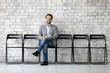 © fizkes - Portrait of smiling Caucasian male job candidate sit on chair wait for interview or recruitment talk in office, happy European man work applicant hiring apply at vacant position, employment concept