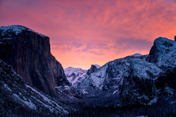 Wall Mural - dramatic sunset over snowy mountains in winter