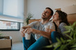 © Nebojsa - Close up photo of happy married couple enjoying having coffee on the floor of their new home. Young couple in love sitting on the floor with cardboard boxes all around them.