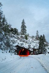 Wall Mural - view of snow covered tunnel with red lights