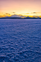 Wall Mural - Vertical view of White Bonneville Salt Flats texture near Salt Lake City, Utah at twilight after sunset with purple and blue sky and horizon