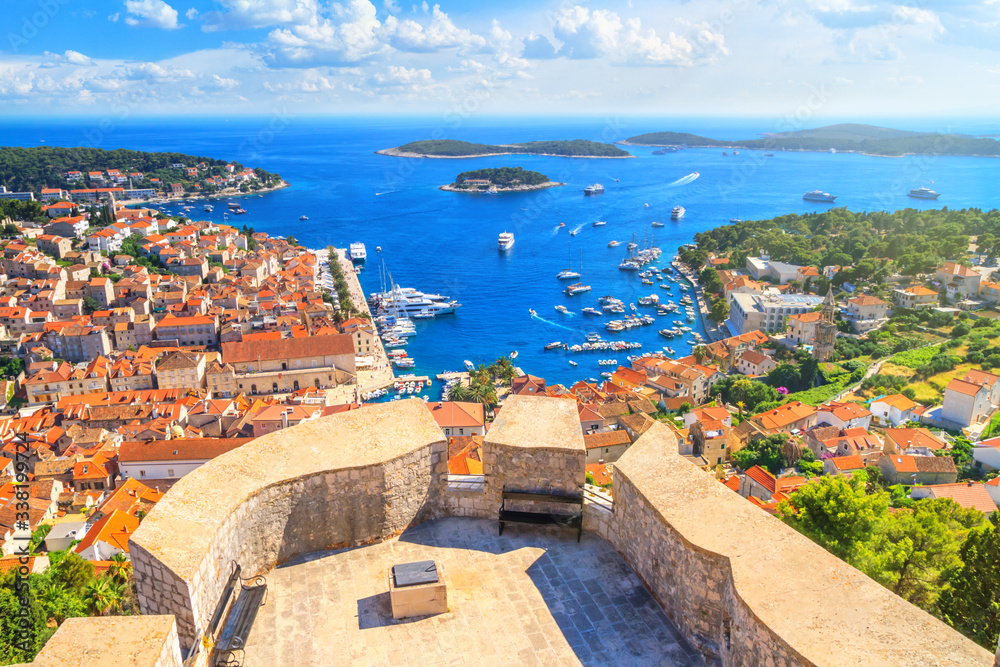 Coastal summer landscape - top view of the City Harbour and marina of the town of Hvar from the fortress, on the island of Hvar, the Adriatic coast of Croatia - obrazy, fototapety, plakaty 