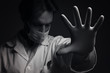 © Teodor Lazarev - Virus mask male doctor wearing face protection in prevention for coronavirus showing gesture Stop Infection