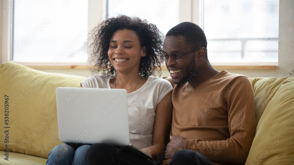 Photo Stock Happy african american family having good time using laptop ...