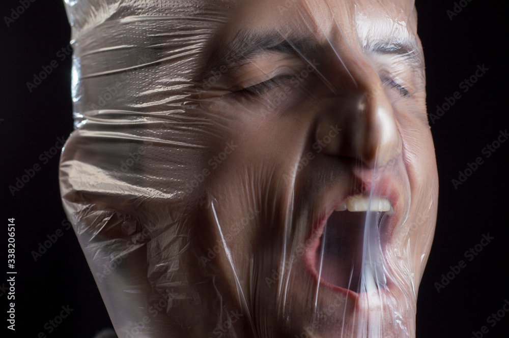 Foto de Stock close up portrait of a plastic bag on the face asphyxiation Adobe Stock