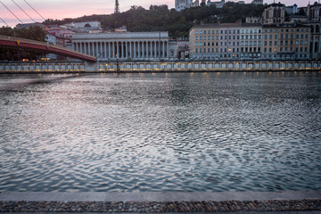 Panorama of the riverbank of Saone river in Lyon, France, at dusk, with Colline de Fourviere hill behind. Lyon is the second biggest city of France and a major touristic destination