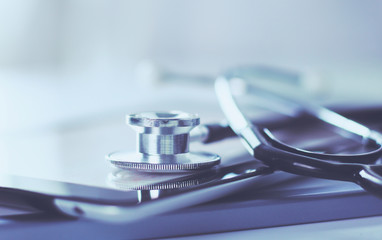 Wall Mural - Medical equipment: blue stethoscope and tablet on white background. Medical equipment