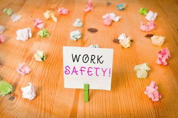 Poster - Handwriting text Work Safety. Conceptual photo policies and procedures in place to ensure health of employees Colored crumpled papers empty reminder wooden floor background clothespin