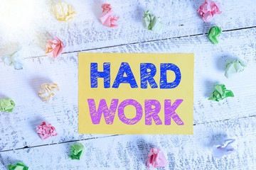 Wall Mural - Conceptual hand writing showing Hard Work. Concept meaning always putting a lot of effort and care into work or endurance Crumpled rectangle squared paper reminder white wood desk