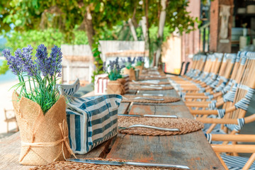 Empty tables ready for guests at the beach restaurant and bar near the sea. Vacation, get away, summer outing, crisis, lockdown concept