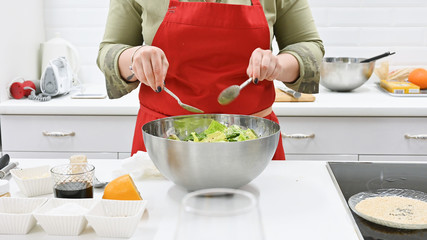 the cook is preparing a salad salad. vegetarian food. cook in the kitchen.