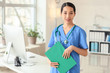 © Pixel-Shot - Female Asian doctor with clipboard in clinic