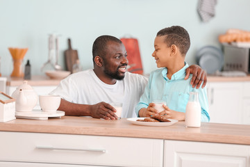 Poster - African-American boy and his father drinking milk in kitchen