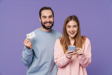 Sticker - Loving couple using mobile phone holding credit card.