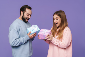 Wall Mural - Loving couple isolated over purple wall