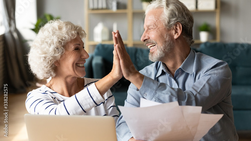 Cuadros en Lienzo Excited older couple giving high five, mature family celebrating success, checki