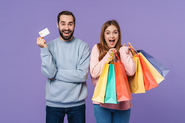 Canvas Print - Optimistic loving couple holding shopping bags and credit card.