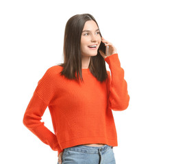 Beautiful young woman talking by mobile phone on white background