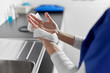 © Syda Productions - hygiene, health care and safety concept - close up of female doctor or nurse drying hands with paper tissue at hospital