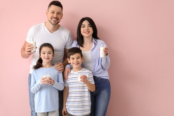 Canvas Print - Family drinking milk on color background