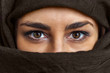 close up female portrait,  brown eyes woman portrait with brown scarf covered her face