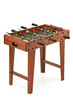 Subject shot of mini table football on the white backdrop. The portable foosball includes plastic players' figures, a mini ball and a score keeper.