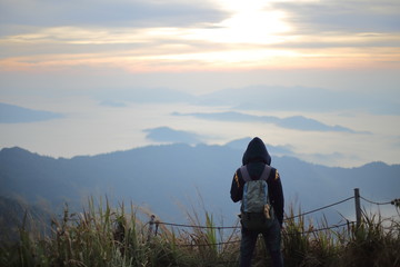 A man standing in the view at Phu Chi Fa National Park, Chiang Rai, Thailand